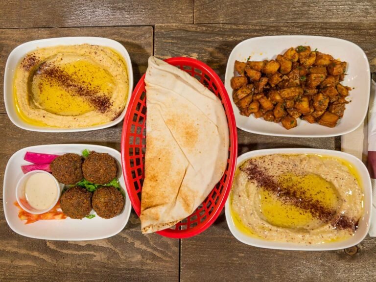 Lebanese appetizers from That Lebanese Place including hummus, baba ghanoush, falafel, batata harra, and pita bread.