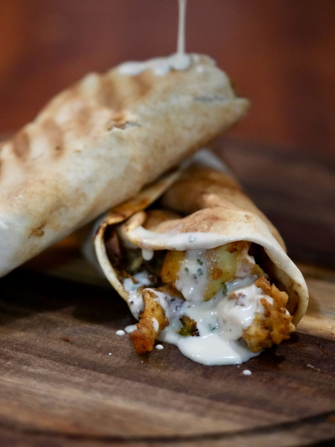 Chicken Shawarma Wrap from That Lebanese Place, filled with marinated chicken, garlic sauce, and vegetables wrapped in warm pita bread.