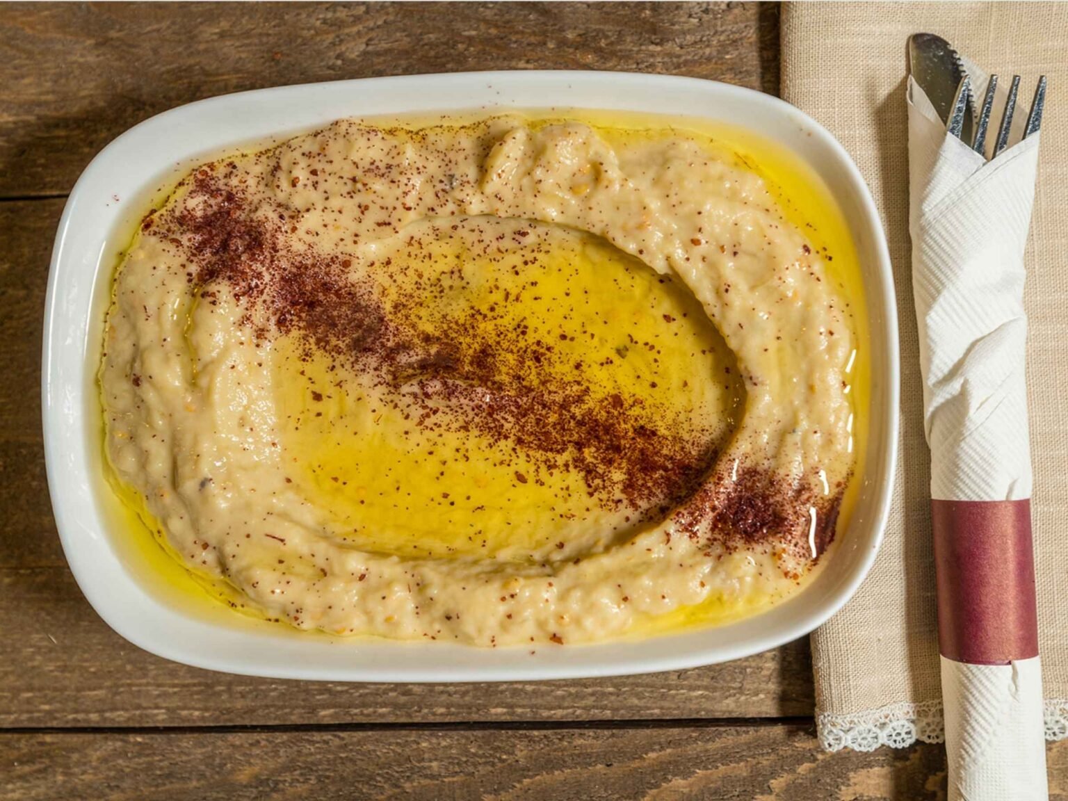 Creamy Lebanese hummus drizzled with olive oil and sprinkled with sumac, served fresh at That Lebanese Place.