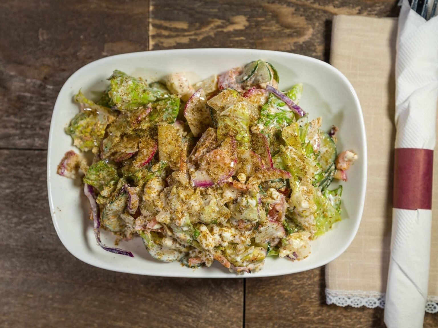 Lebanese salad from That Lebanese Place made with fresh vegetables, feta cheese, garlic sauce, and house dressing.