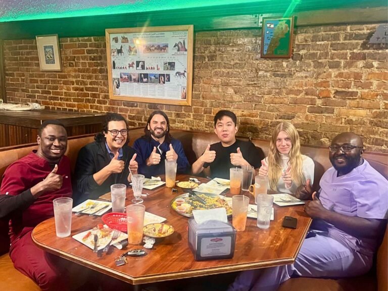 Group of happy diners giving thumbs up after enjoying their meal at That Lebanese Place, showing satisfaction with authentic Lebanese food and warm hospitality.