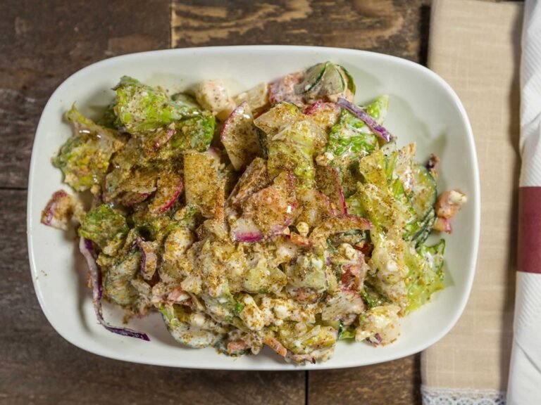 Lebanese salad from That Lebanese Place made with tossed vegetables, feta cheese, garlic sauce, and house dressing.