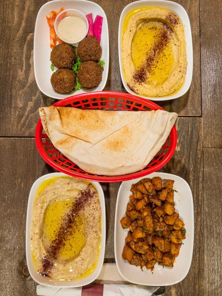 The TLP Sampler from That Lebanese Place featuring a selection of four Lebanese appetizers chosen by the diner, served with warm pita bread.