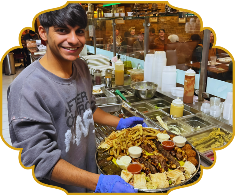 That Lebanese Place staff member carrying a large family platter of mixed grilled meats and Lebanese sides
