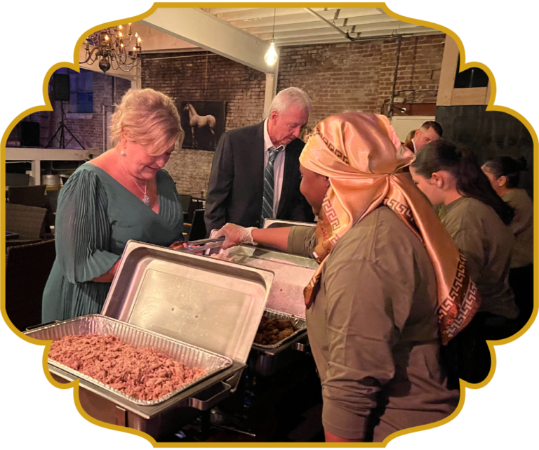 Guests being served Lebanese food by That Lebanese Place at a catering event