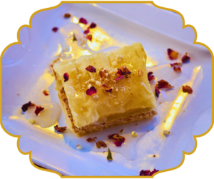 Baklava with flaky phyllo pastry layers, honey syrup, and crushed pistachios at That Lebanese Place Springfield