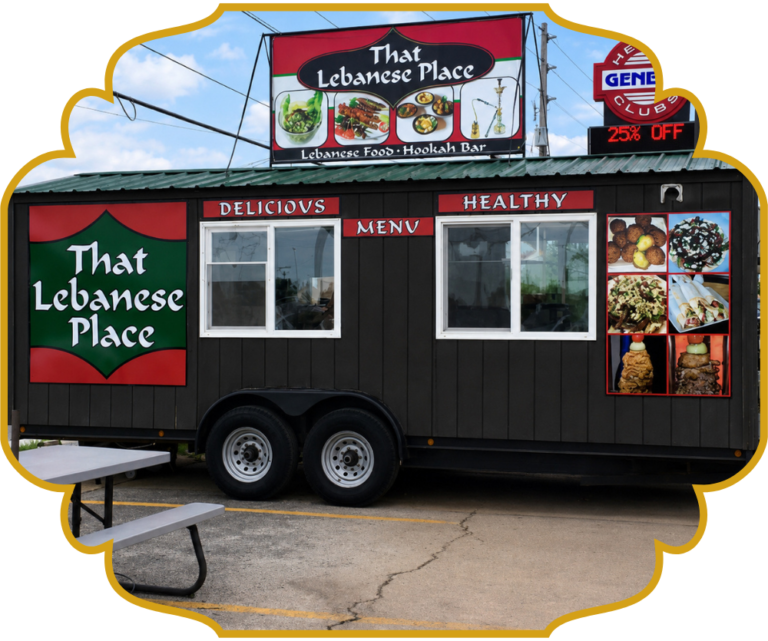 The original That Lebanese Place food truck, a black trailer with red and green signage reading "That Lebanese Place, Lebanese Food, Hookah Bar," parked beside a picnic bench before the C-Street restaurant opened.