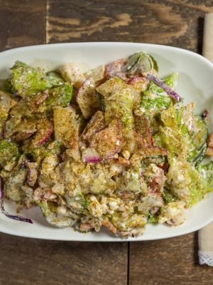 Lebanese salad from That Lebanese Place made with fresh vegetables, feta cheese, garlic sauce, and house dressing.