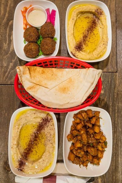 The TLP Sampler from That Lebanese Place featuring a selection of four Lebanese appetizers chosen by the diner, served with warm pita bread.